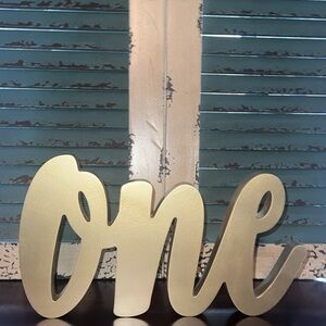 Gold Decorative cursive “One' Sign